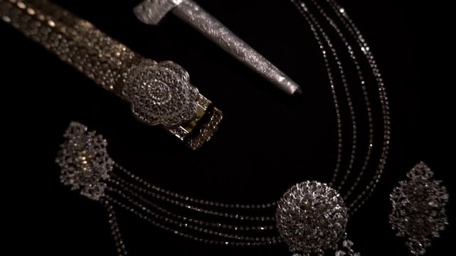 Traditional Malay jewelry and accessories for wedding attire, including belt, dagger, and silver ornaments, cultural heritage display.