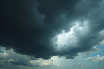 Abstract Swirls of Dark Storm Clouds in a Moody Sky An abstract depiction of dark storm clouds with intricate, swirling patterns and a sense of immense energy. The colors are primarily deep grays and
