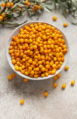Sea buckthorn berries in bowl preparing healthy food