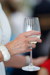 Woman drinking a glass of white wine. France.