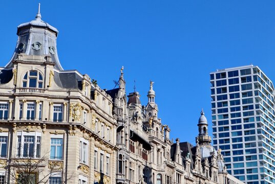 Antwerp architecture with old ornate buildings contrasting modern high rise in urban landscape. Belgium