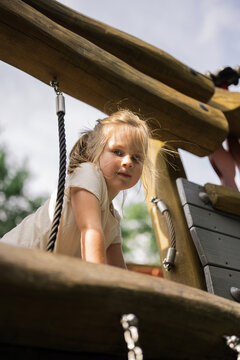 Little girl at playground, sunny autumn family day out
