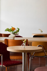 Cozy cafe interior with wooden tables and colorful chairs