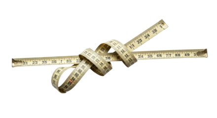 Flexible measuring tape twisted with wooden ruler isolated on black background, perfect for tailoring and sewing projects