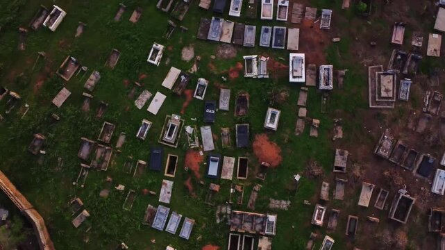 Top down view of a large cemetery in Nigeria, Africa. The drone spins frantically over the graves
