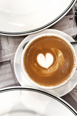 Drinking Coffee. Flat White with Heart Latte Art Served on Cafe Table. 