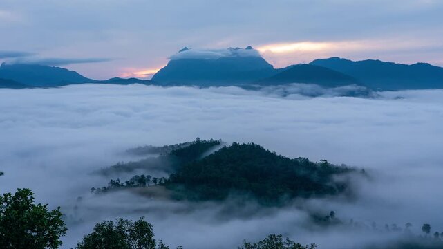 Sunrise over the mountains in green season, moving fog in foreground of Doi Laung Chiang Dao, viewpoint from DenTV Kong City, Chiangmai, Thailand