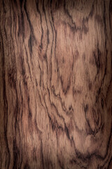 Fototapeta premium background is made of old red wood. an old board. the texture of a rustic table. bubinga, essingang, ebana, kevazingo, akume, waka, a place for a text or object, frame, vignetting
