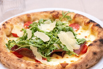 Freshly baked pizza coming out of the oven in a traditional Italian pizzeria setting