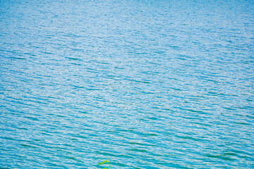 blue water background Aerial view of beautiful sea lake surface. Captivating aerial view of a vast turquoise ocean, showcasing the gentle ripples and shimmering light reflections on the surface