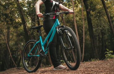 Fototapeta premium woman rides a bicycle along a forest path, embracing a healthy and active lifestyle in stylish sportswear
