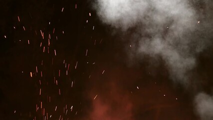 Abstract smoke and embers rising against a dark and dramatic background - Powered by Adobe
