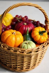 Bountiful Harvest Basket A close up, overhead view of a rustic woven basket overflowing with a colorful assortment of fresh autumn produce. Include pumpkins, various types of squash, ripe apples,