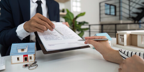 Property Agreement. Real estate agent explaining contract details to client.