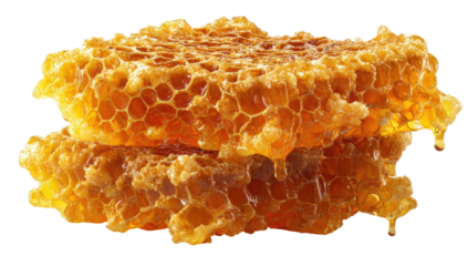 Close-up of golden honeycomb slices, some honey dripping, stacked and isolated on a black background