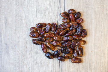 Dates forming heart on wooden background for healthy love