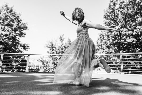 Woman dancing outdoors expressing freedom and joy