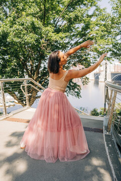 Woman dancer performing contemporary ballet in urban park