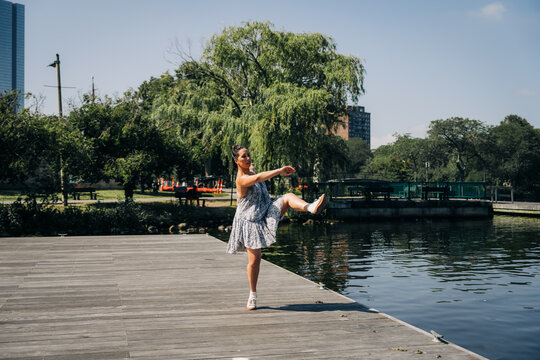 Woman performing contemporary dance on park dock