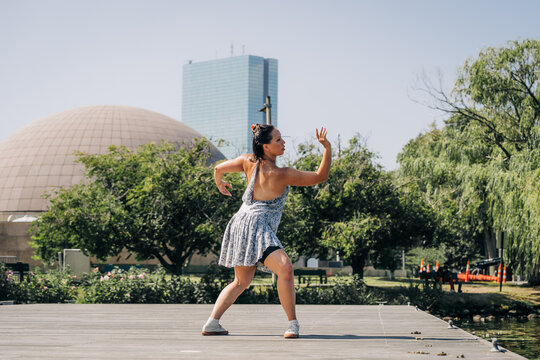 Woman dancer performing contemporary dance steps outdoors in boston