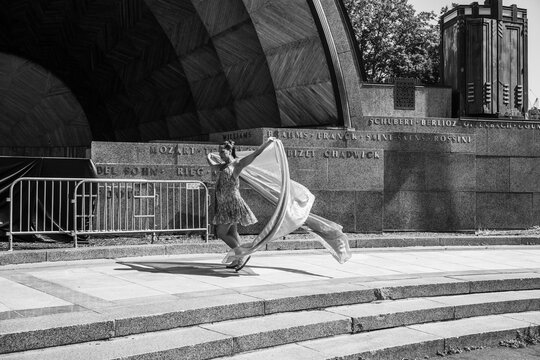 Woman performing freedom dance with fabric at hatch memorial shell