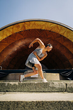 Woman dancing expressing movement near hatch shell