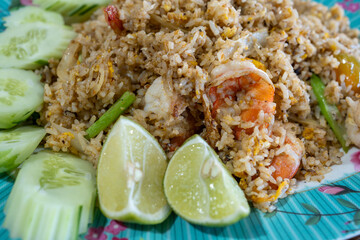 Close-up of Thai Shrimp Fried Rice (Khao Pad Goong) with Lime and Cucumber