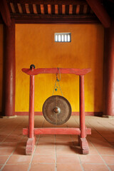 A big  brass gong inside an ancient temple in Hoi An, Vietnam. 