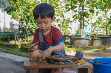 Child Intently Playing and Exploring with Clay