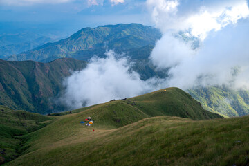 Group of people with his tents are taking a view of Mountain Range view point in Myanmar (Burma) with sea of cloud (Mulayit Taung) and sunrise