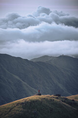 A man with his tent is taking a view of Mountain Range view point in Myanmar (Burma) with sea of cloud (Mulayit Taung) and sunrise