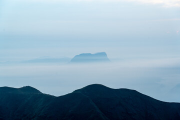 Mountain peak covered by sea of cloud below in Myanmar country