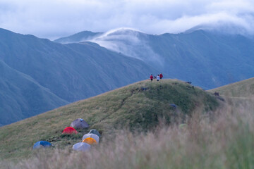 Group of people with his tents are taking a view of Mountain Range view point in Myanmar (Burma) with sea of cloud (Mulayit Taung) and sunrise