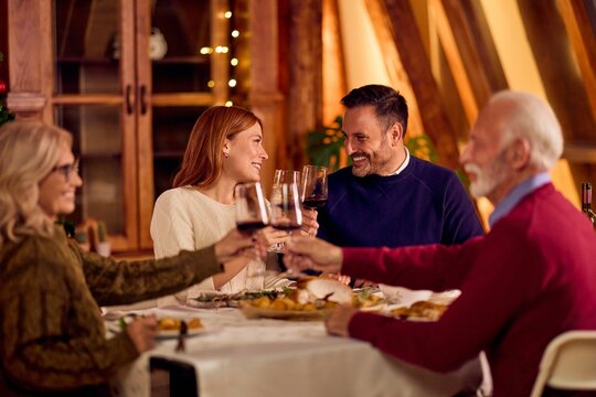 Friends and Family Toast at a Warm Dinner Party for New Year Celebration - Powered by Adobe