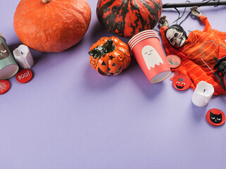 Halloween purple frame background flatlay with pumpkins and party decor