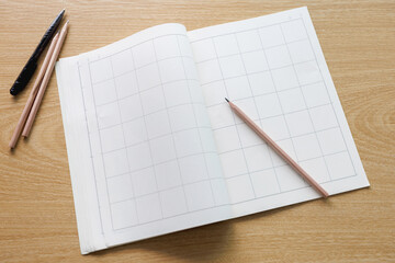 Drafting paper or graph paper with pencil under warm incandescent lighting