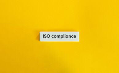 ISO Compliance Concept on White Letter Tile with Yellow Background – Minimalist Business and Quality Management Design