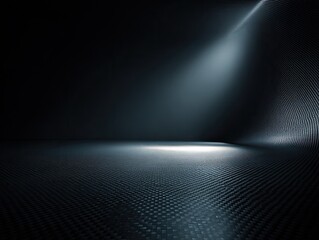 A dark, textured surface curves upwards, illuminated by a spotlight. Dramatic shadow