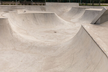 Multiple smooth concrete ramps and bowls are designed for skateboarding and BMX riding at a...