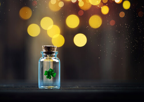 4-leaf clover, symbol of luck, in a mini bottle against a festive, bright background