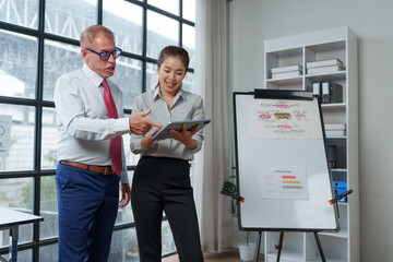 Business professionals discussing strategy using digital tablet in office