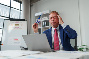 Businessman feeling headache from work related stress