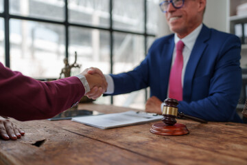 Lawyer and client shaking hands after negotiation