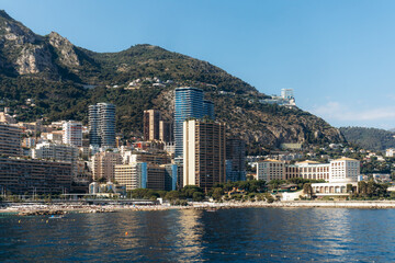 Obraz premium View of La Rousse district in Monaco from Mareterra eco-district with seaside buildings and hills in the background