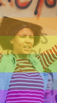 Animation of rainbow over diverse protesters with banners