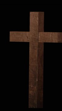 Animation of wooden cross appearing on black background