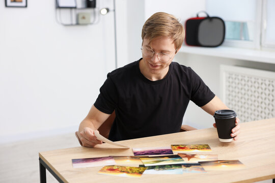 Professional photographer working at wooden table in studio