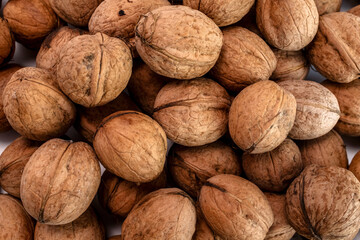 Unshelled walnuts showing natural texture, rough surface, and organic brown color. Ideal for healthy food concepts, ingredient backgrounds, nutrition visuals, or natural product design