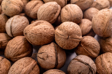 Unshelled walnuts showing natural texture, rough surface, and organic brown color. Ideal for healthy food concepts, ingredient backgrounds, nutrition visuals, or natural product design