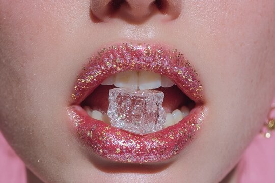 Glossy pink glitter lips biting clear ice cube macro close-up - Powered by Adobe